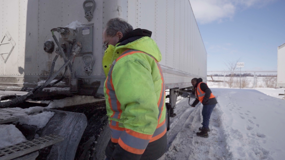 Workers inspecting a truck.