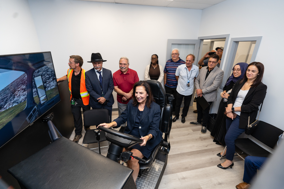 Visitors demoing one of the truck driving simulators at the new campus.