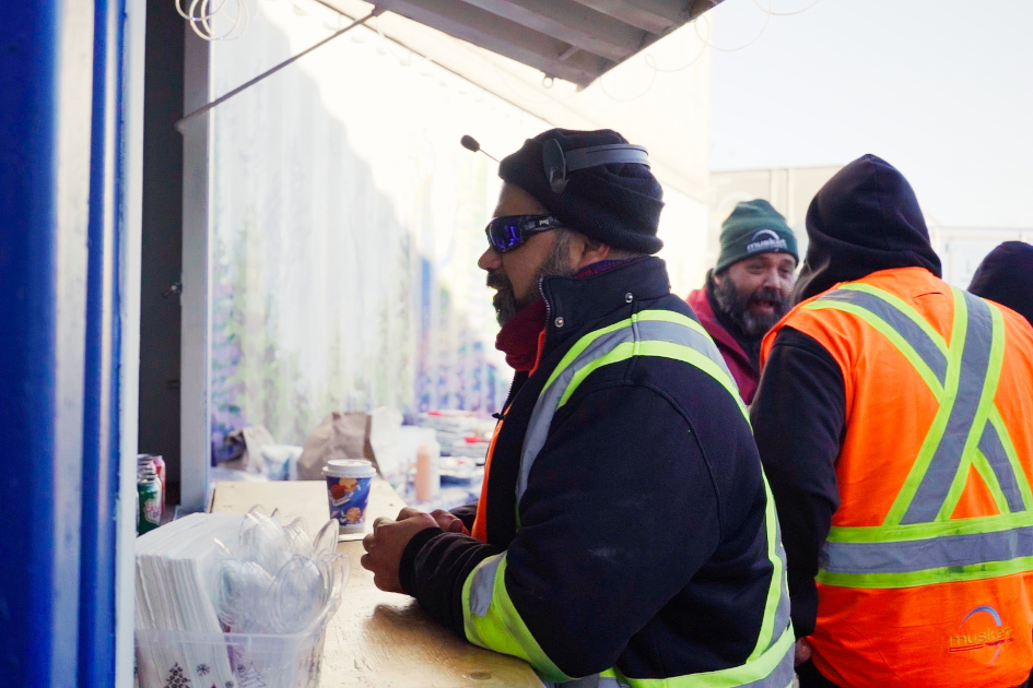 Workers looking at the shipping container Musket Transport is providing.